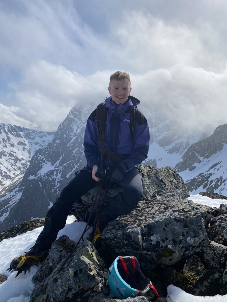 Portrait of Andy Batey, founder of Coastal Munro Marketing, on a snowy mountain summit